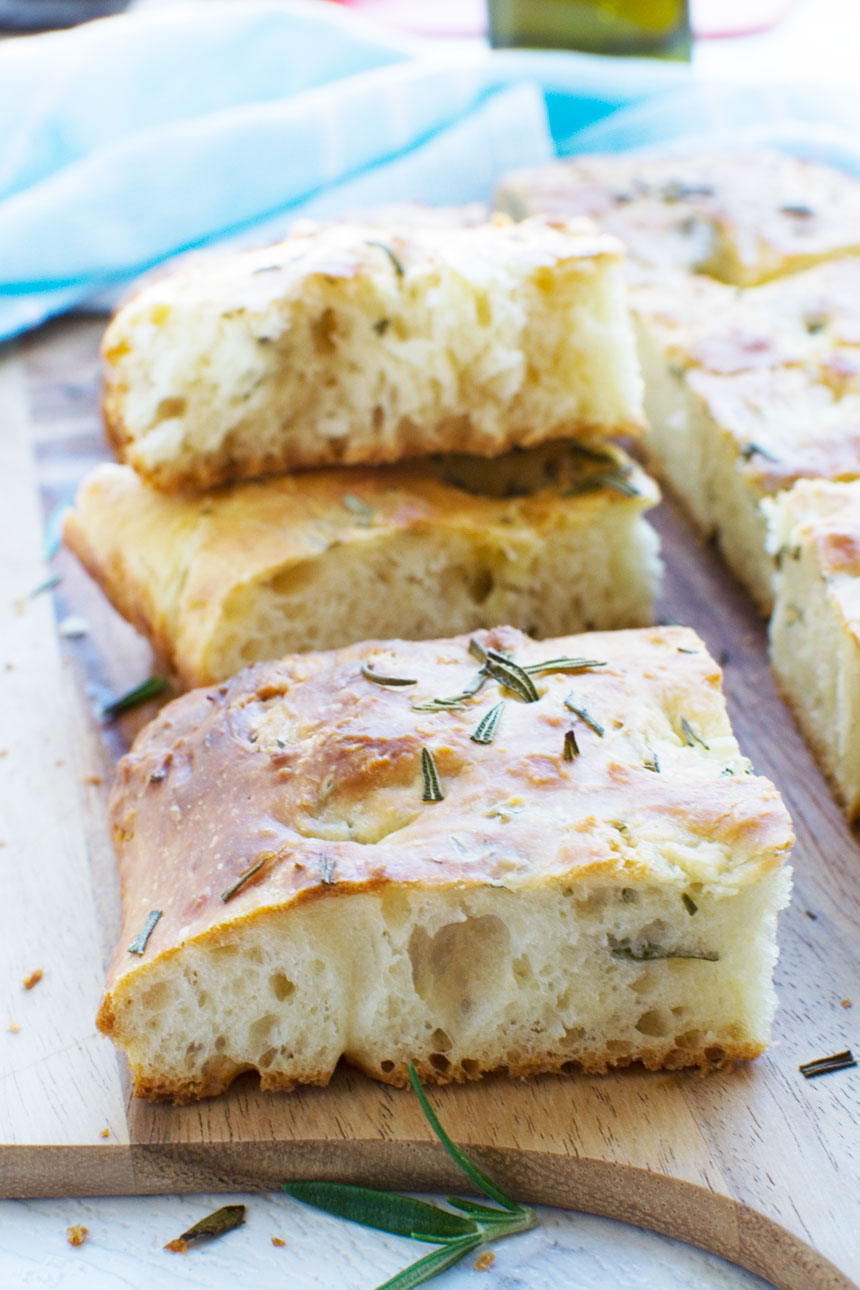 Squares of focaccia bread on a wooden cutting board