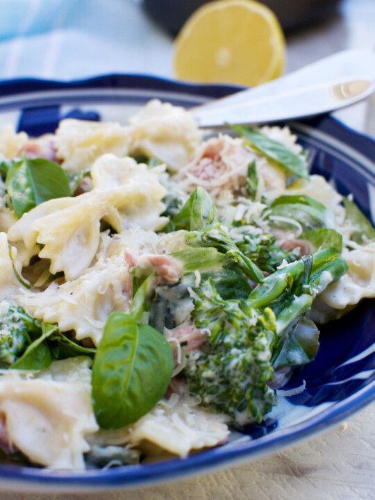 A plate of food with broccoli, with Lemon ricotta pasta and Farfalle with a fork in it