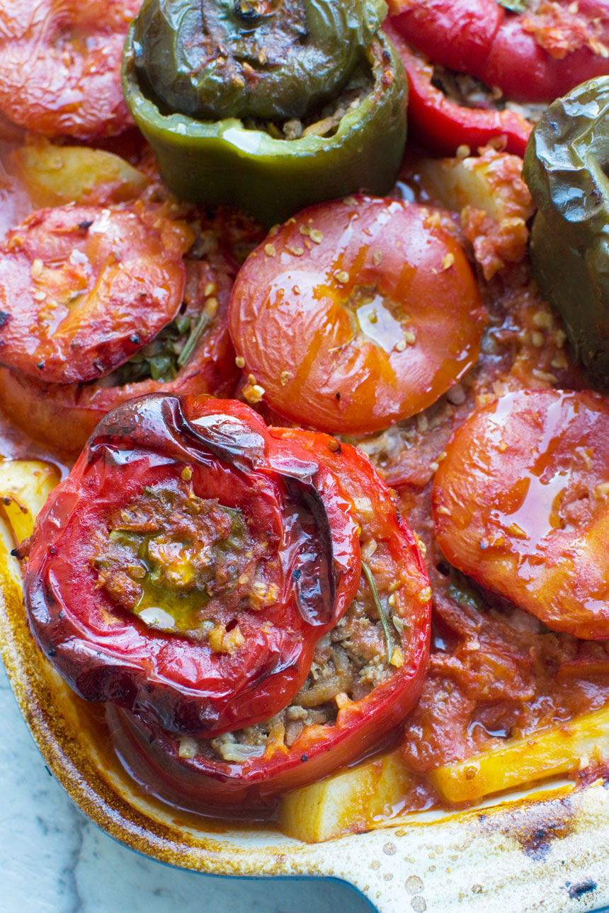 A close up of a pan of cooked gemista or Greek stuffed peppers and tomatoes