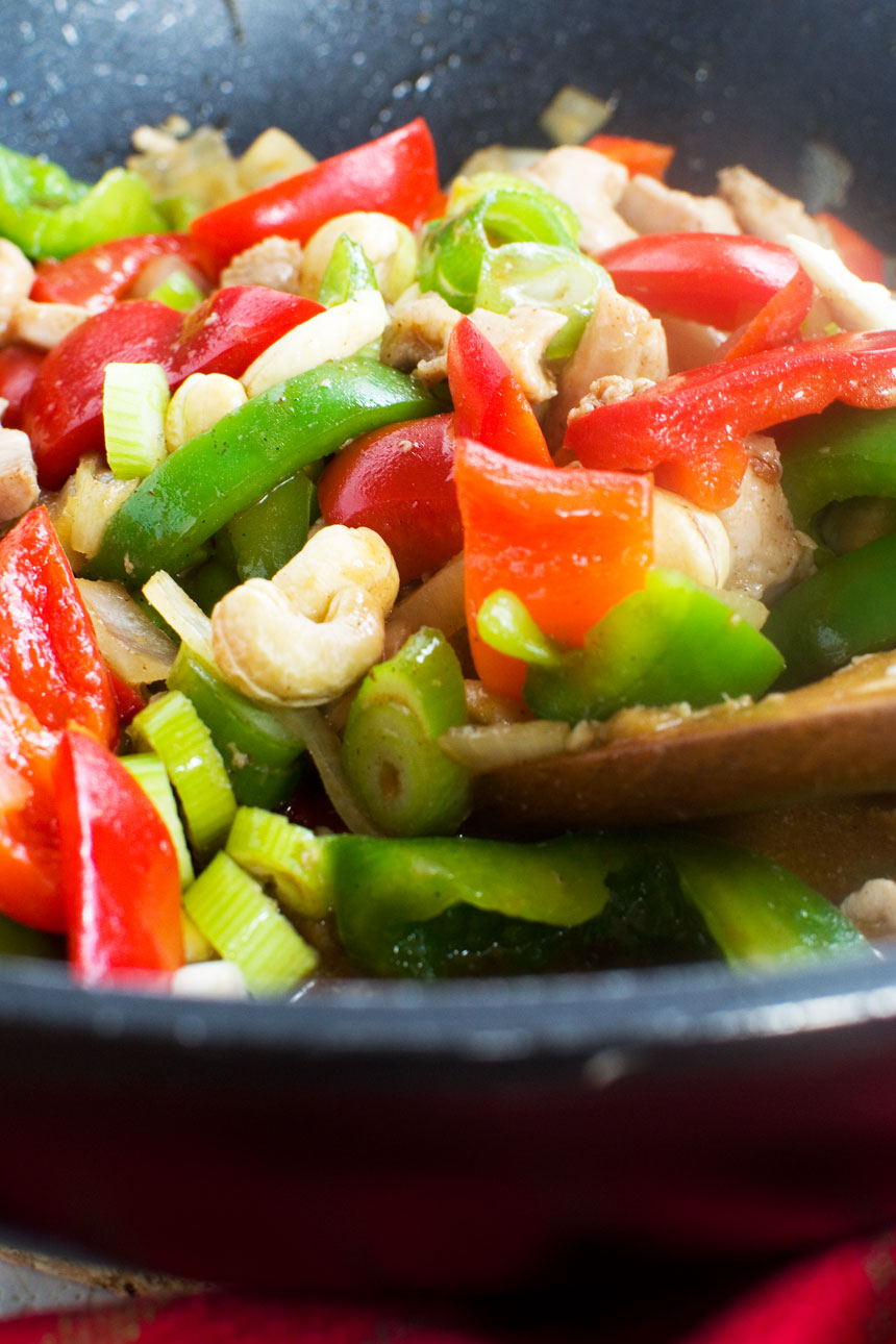 A pan of chicken with cashew nuts and peppers