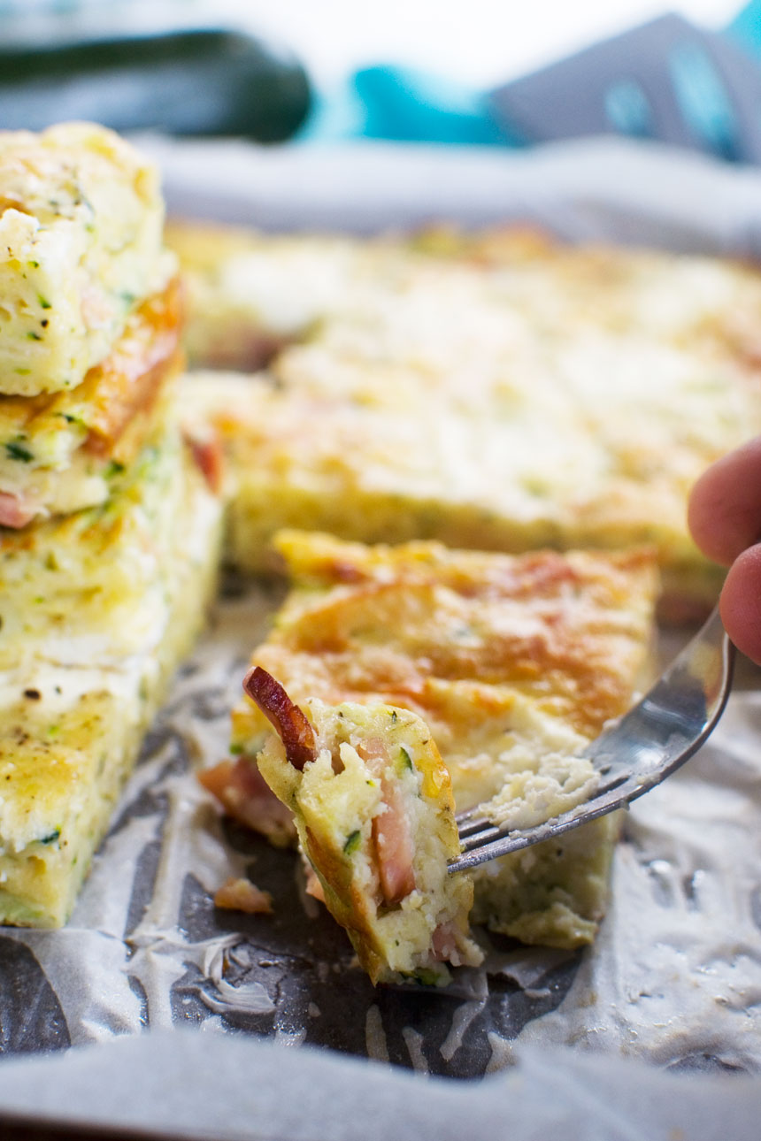 Someone eating a slice of zucchini slice with a fork