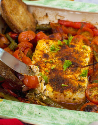 A dish of baked feta with tomatoes, feta and olives