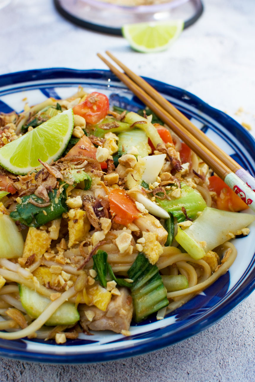 A dish of mee goreng basah or spicy Indonesian noodles with chopsticks