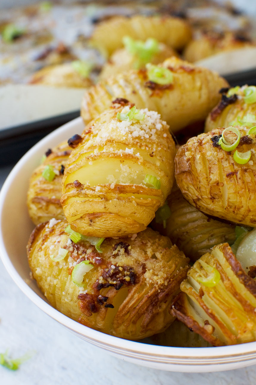 A close-up bowl of mini parmesan and garlic hasselback potatoes