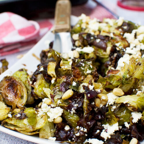 A plate of honey balsamic brussels sprouts with pine nuts and feta