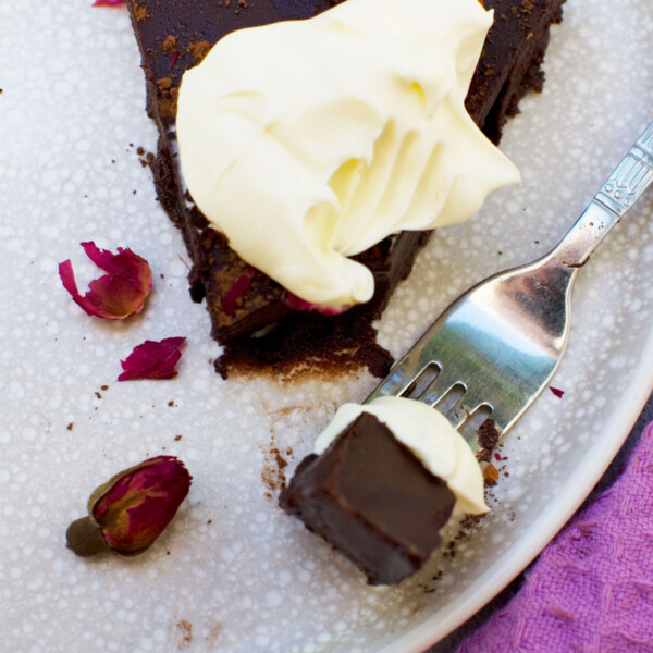 A slice of no bake chocolate truffle cake with cream on top from above