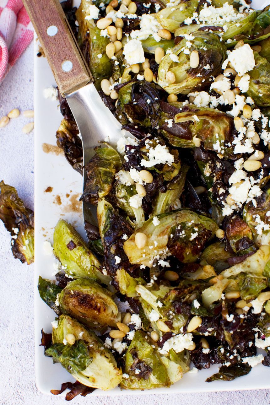 A plate of honey balsamic brussels sprouts with pine nuts and feta from above