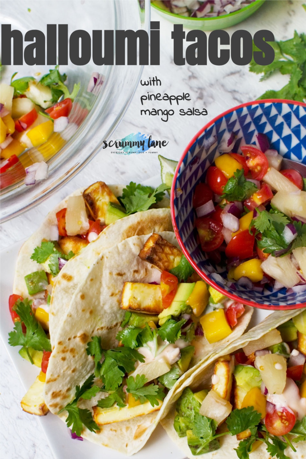 A close up of 3 halloumi tacos with pineapple mango salsa with a grey title on for Pinterest