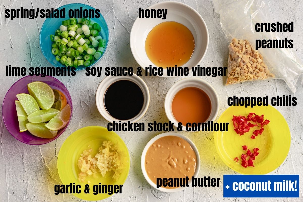 All the ingredients needed to make spicy peanut butter chicken, except the chicken and coconut milk, so spring onions, honey, lime, soy sauce, rice wine vinegar, chicken stock and cornflour, crushed peanuts, chilis, garlic, ginger and peanut butter