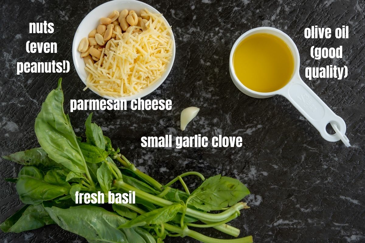 Picture of the ingredients needed to make pesto: nuts, olive oil, parmesan cheese, garlic, fresh basil