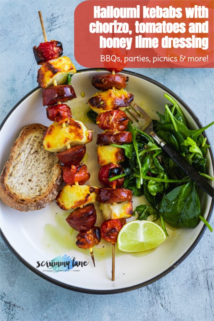 2 halloumi kebabs with chorizo and tomatoes on a white plate from above with a title on it for Pinterest