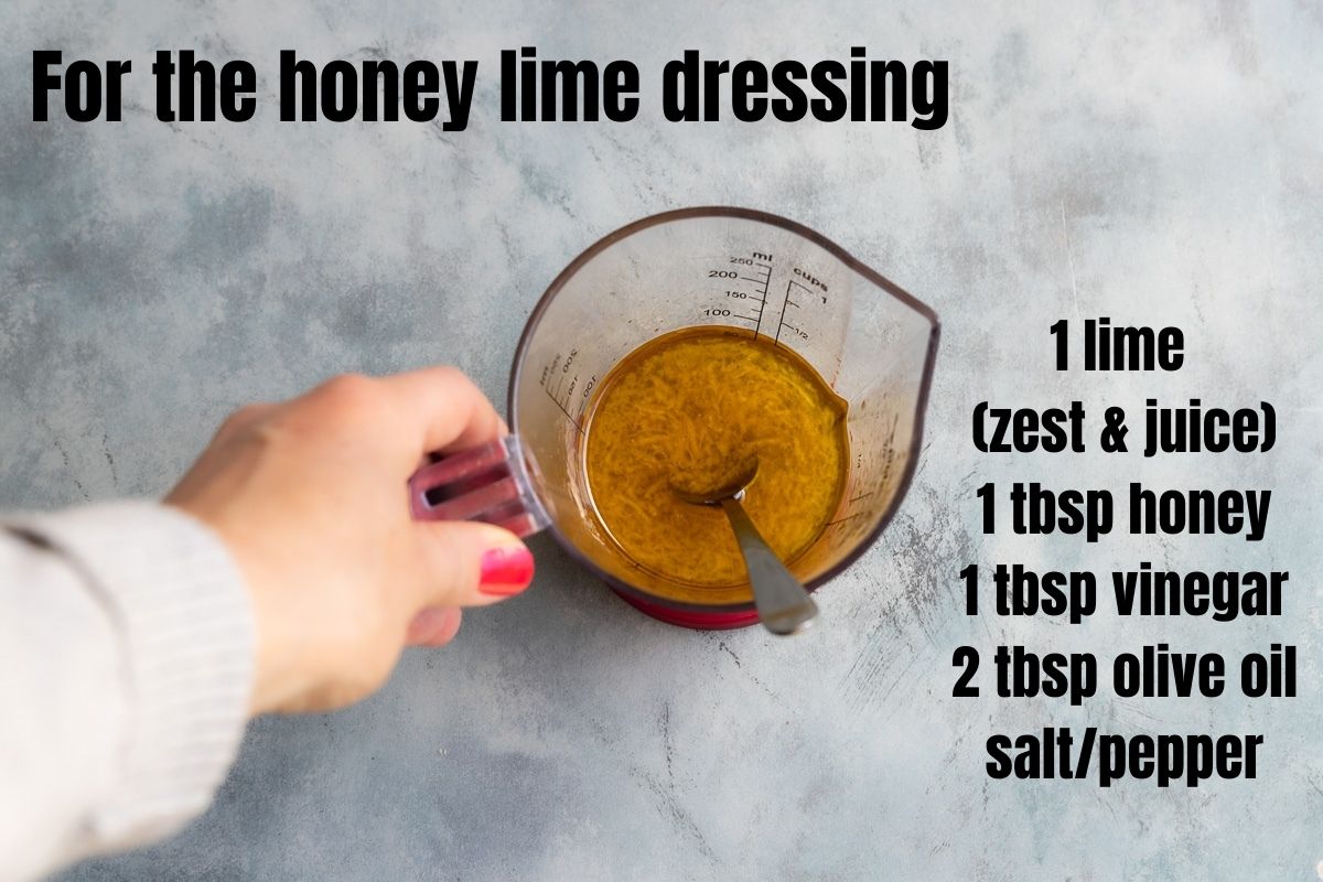 Someone holding a jug of honey lime dressing for halloumi skewers. There's also a list of the ingredients written on the image: 1 lime, honey, vinegar, olive oil, salt/pepper.