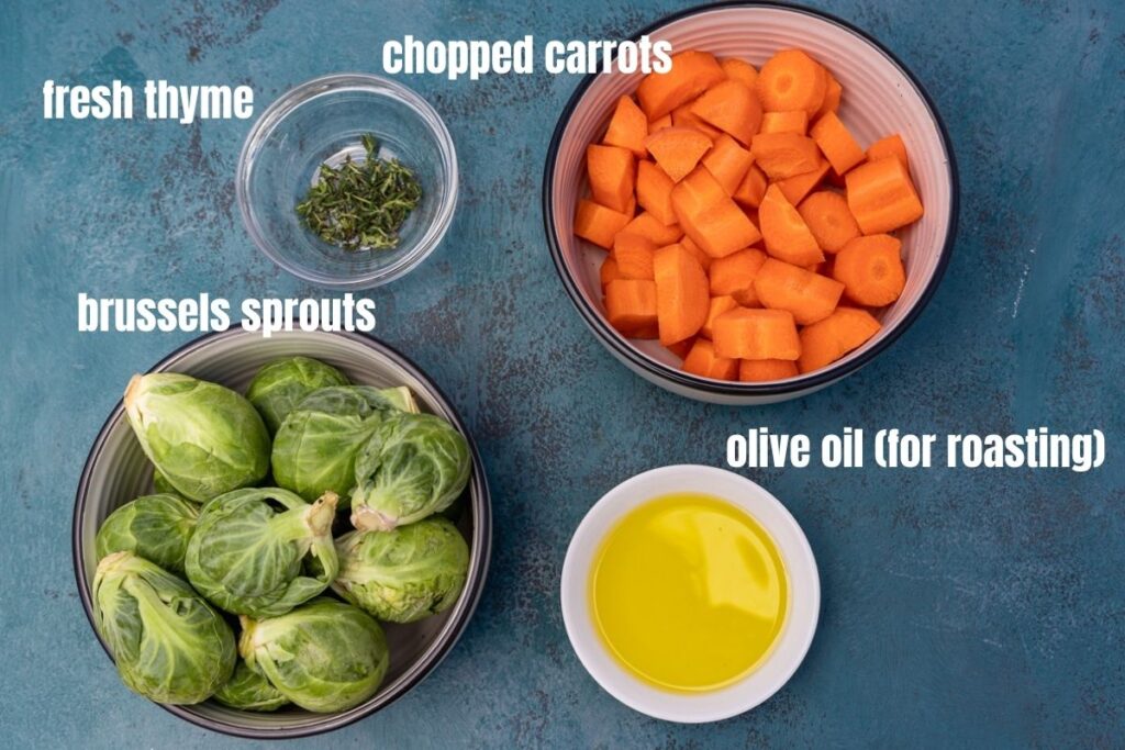the 4 ingredients needed for brussels sprouts and carrots including fresh thyme, chopped carrots, brussels sprouts and olive oil