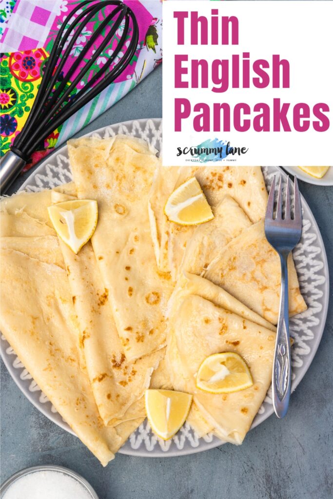 Thin English pancakes folded on a grey white plate with title on it for Pinterest