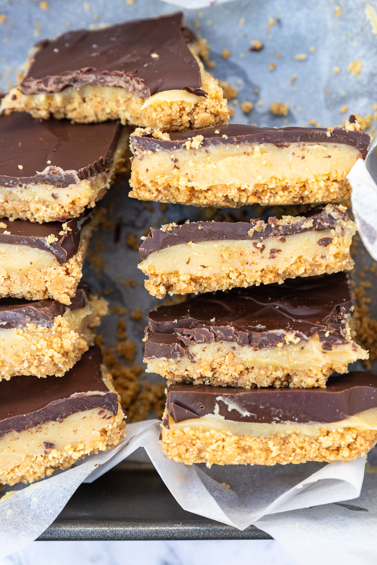 Closeup of slices of no-bake caramel slice on their sides in a baking tin