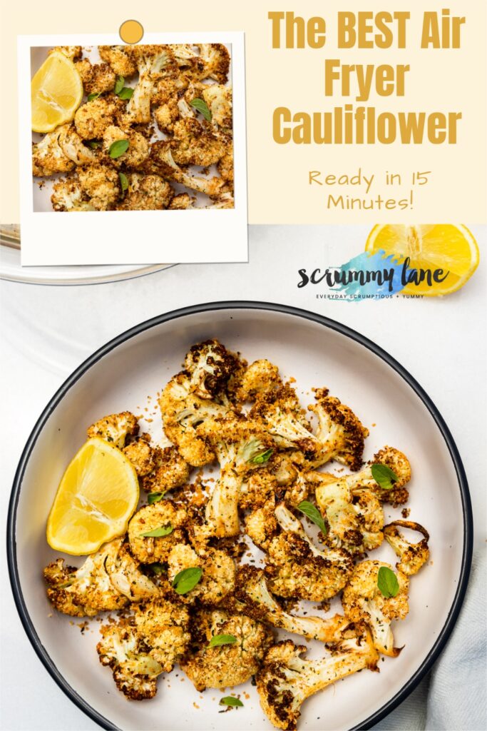 Overhead view of a big dish of air fried cauliflower with a lemon segment and fresh herbs on top and with a title on it for Pinterest that says The Best Air Fryer Cauliflower Ready in 15 minutes.