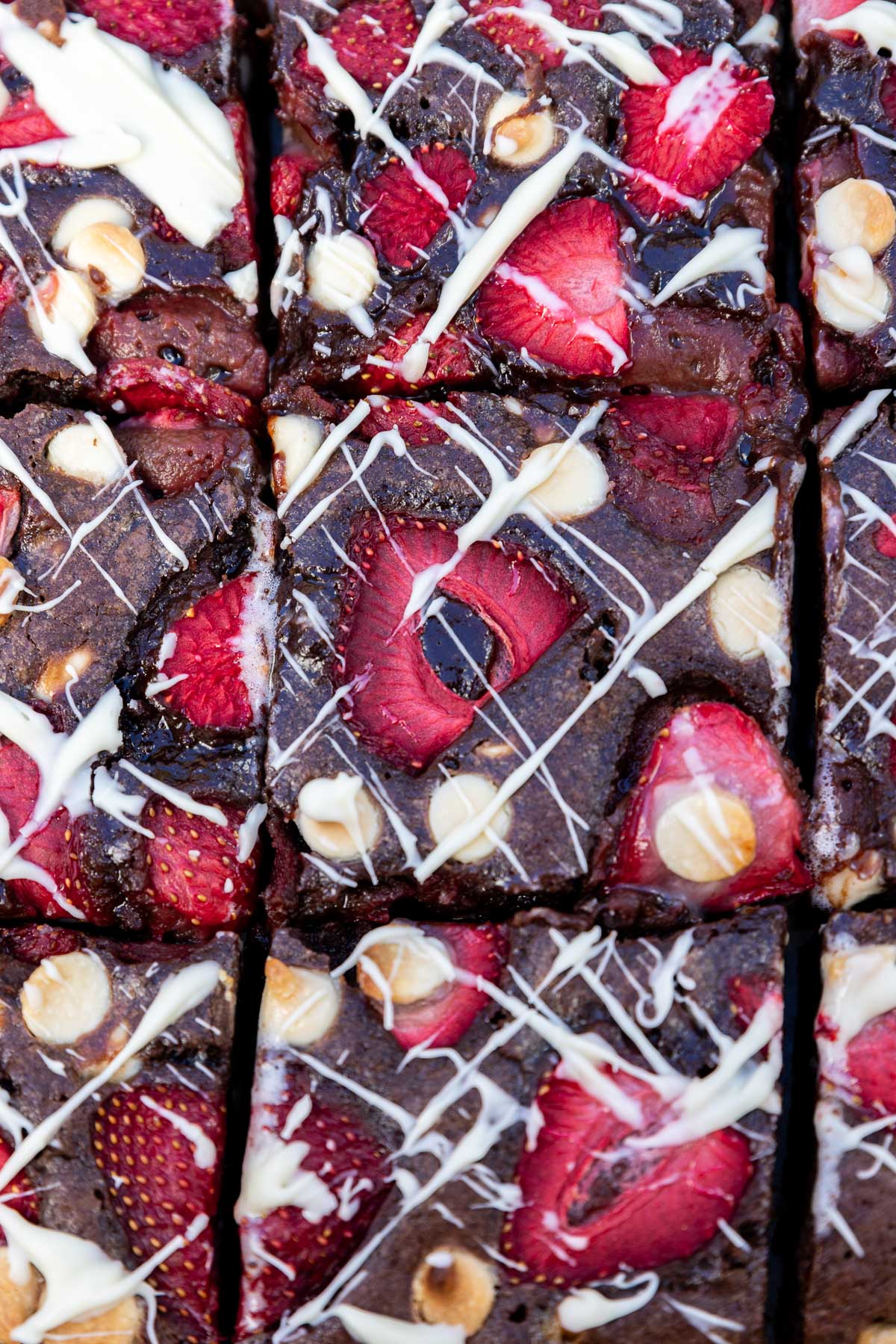 A closeup of the top of a pan of strawberry and white chocolate brownies.