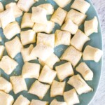 Overhead view of raw homemade 3-ingredient ricotta gnocchi on a blue plate.