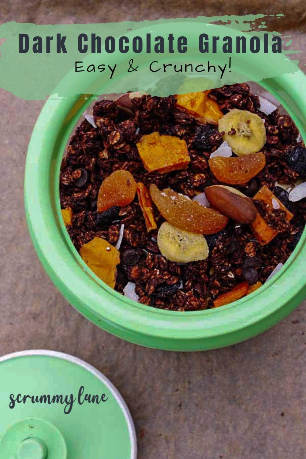 Overhead view of a green container of dark chocolate chip granola, with a title on it for Pinterest.