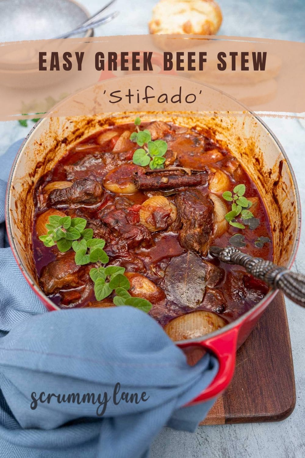 A red dutch oven with Greek beef stew or Stifado in it, with a blue tea towel and with a title on it for Pinterest.