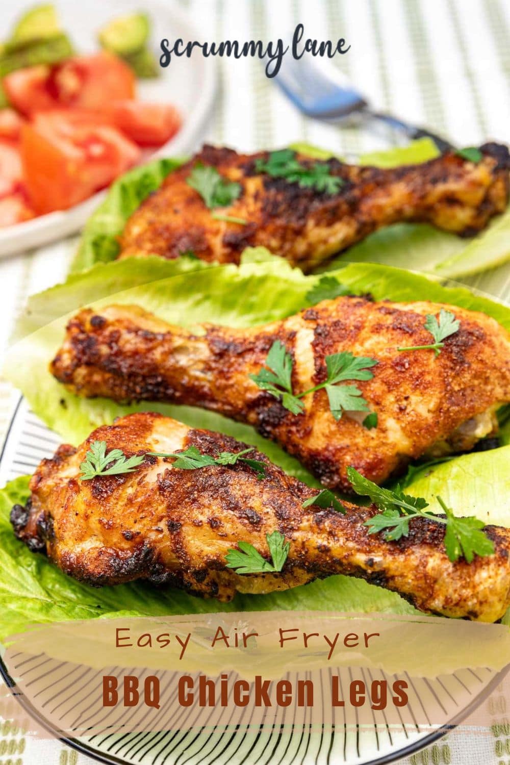 Closeup of BBQ air fryer chicken legs on lettuce leaves, with a title on it for pinterest.