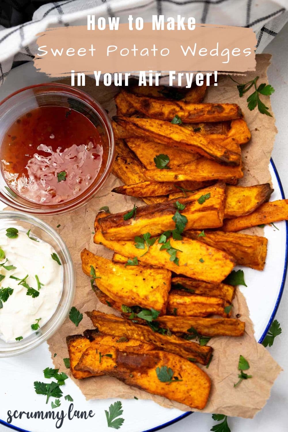 A Pinterest pin showing air fried sweet potato wedges on a sheet of baking paper and a blue-rimmed white plate, with a title on it.