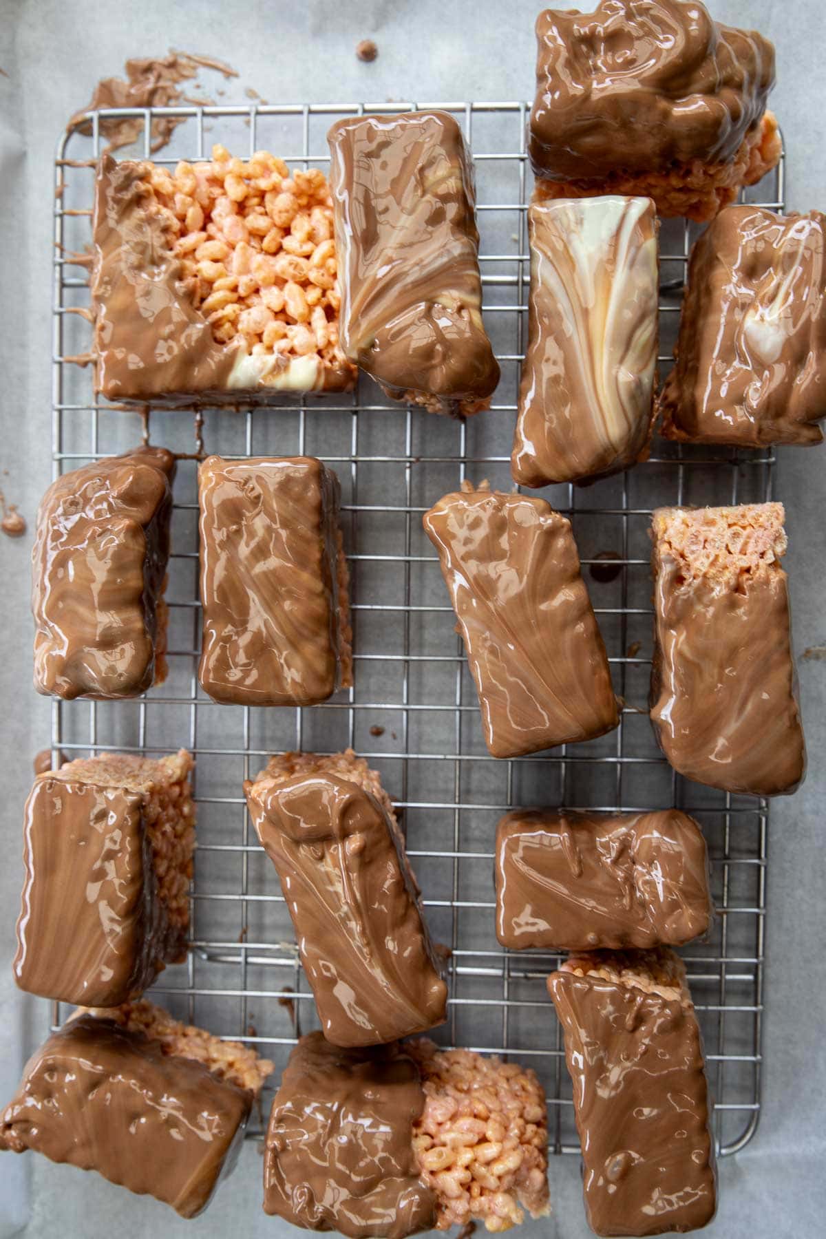 The treats dipped into chocolate and set on a cooling rack to dry.