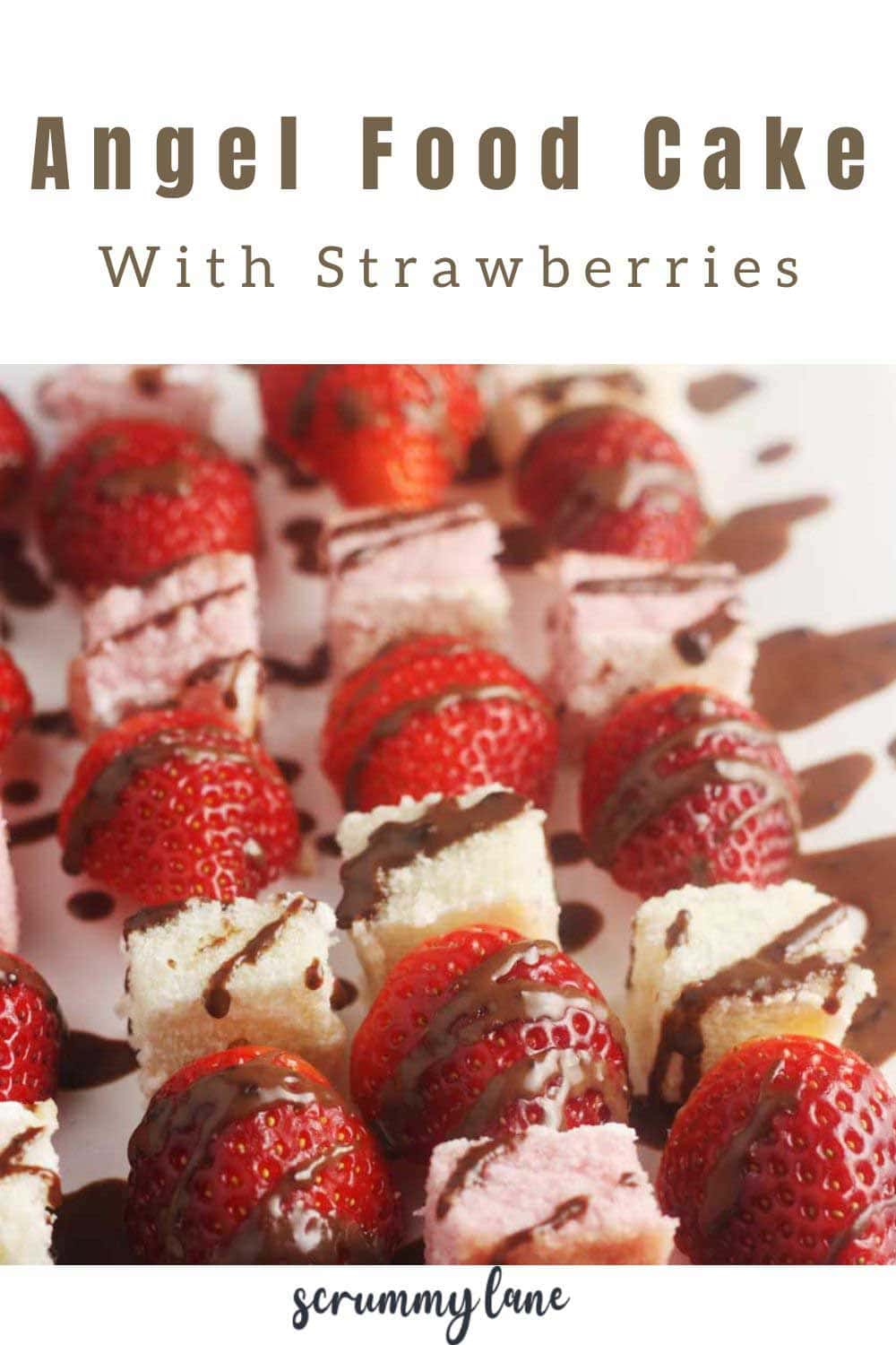 A Pinterest pin with a closeup of angel food cake with strawberries dessert with chocolate sauce drizzled over them and a title at the top.