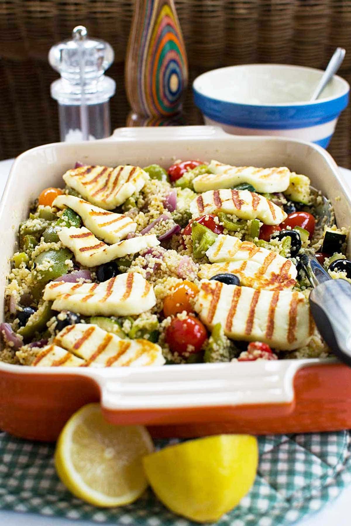 Closeup of the dish of baked couscous with grilled halloumi on top.