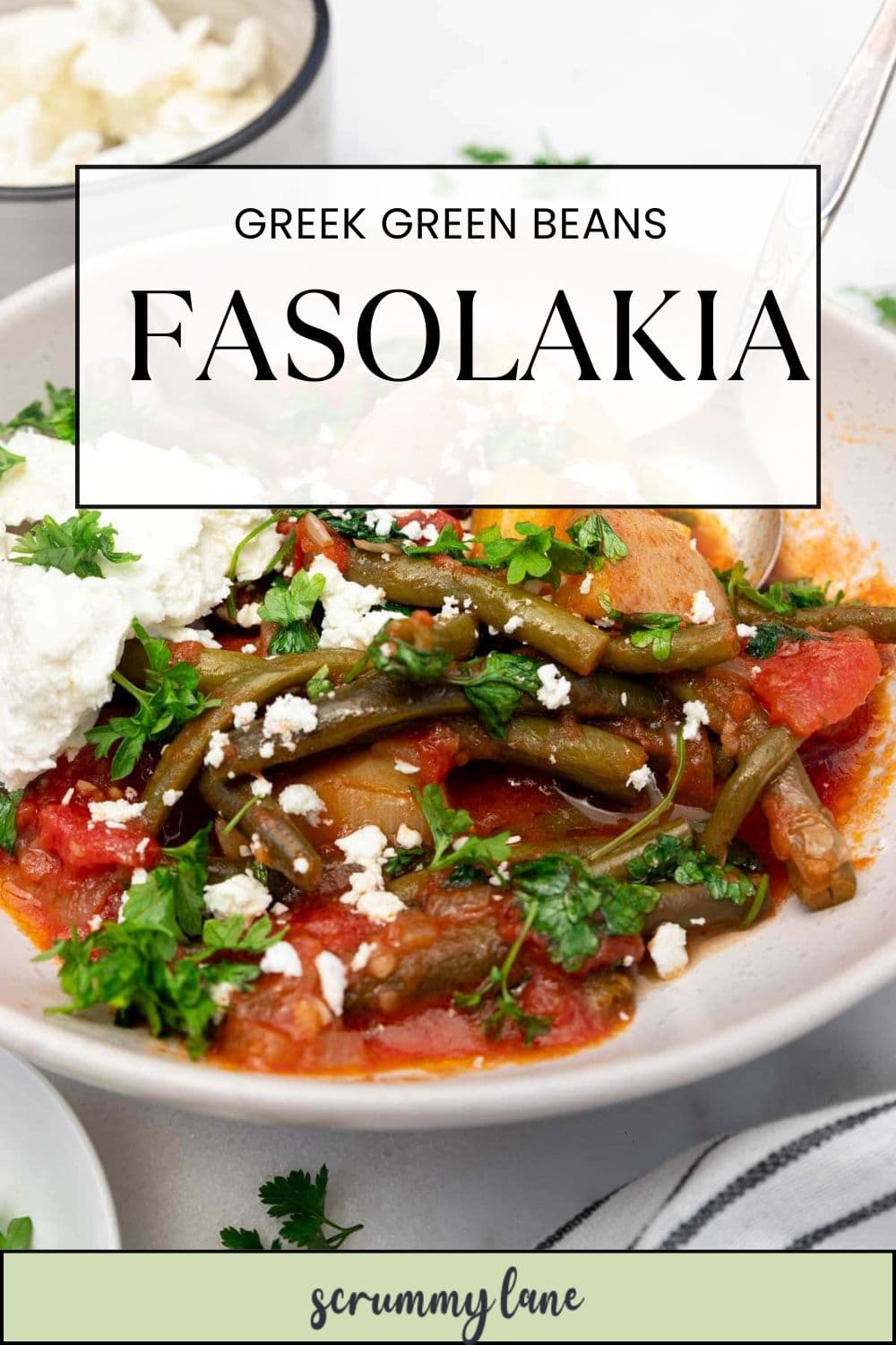 A closeup of a dish of Greek green beans, with a title on it for Pinterest that says Greek green beans fasolakia.
