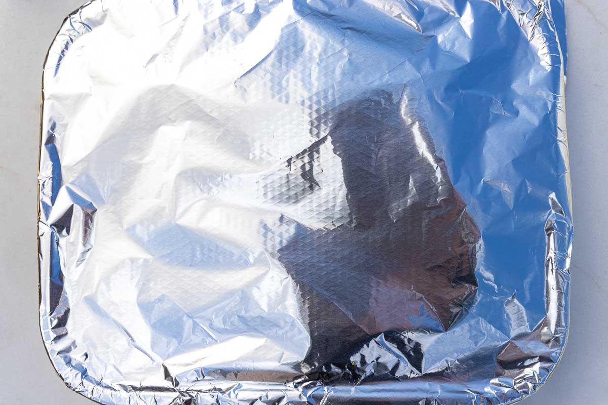 A rectangular baking pan covered tightly with aluminium foil.